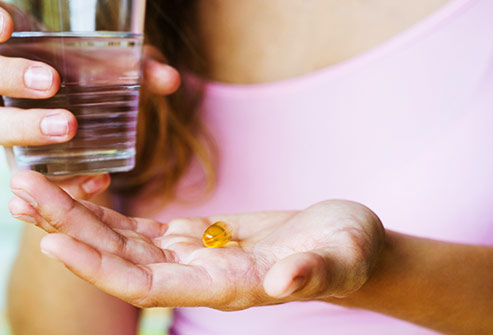 getty_rf_photo_of_woman_holding_a_supplement